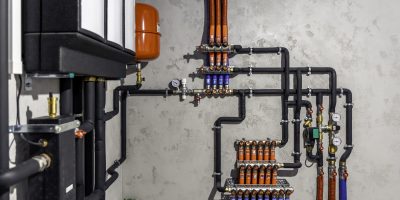 A modern electric boiler room. Equipment for modern heating system as a boiler, heater,pipes, expansion tank and other.